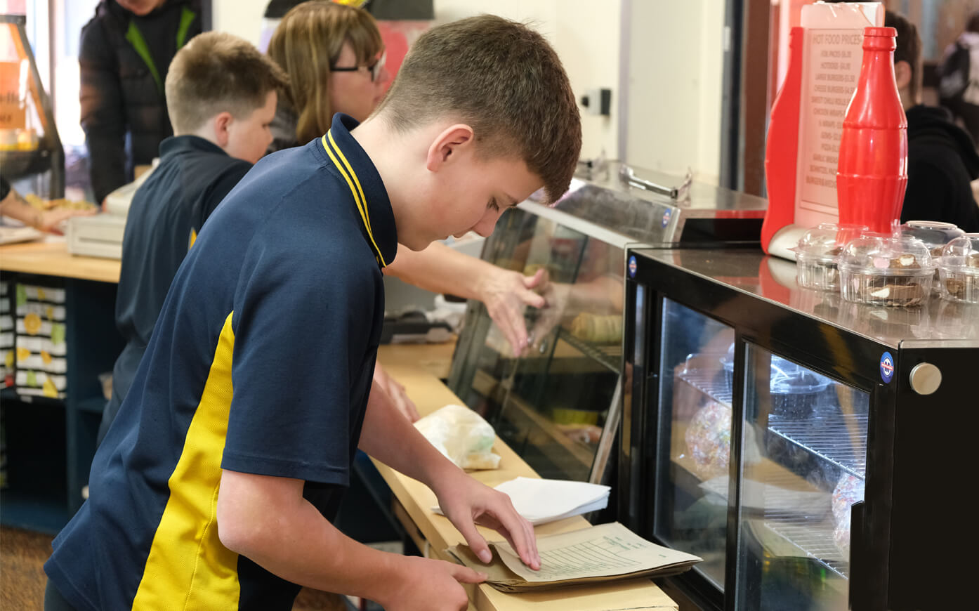 Metro Canteens Adelaide, canteen outsourcing - Adelaide image of primary school boy placing a lunch order at the school canteen.